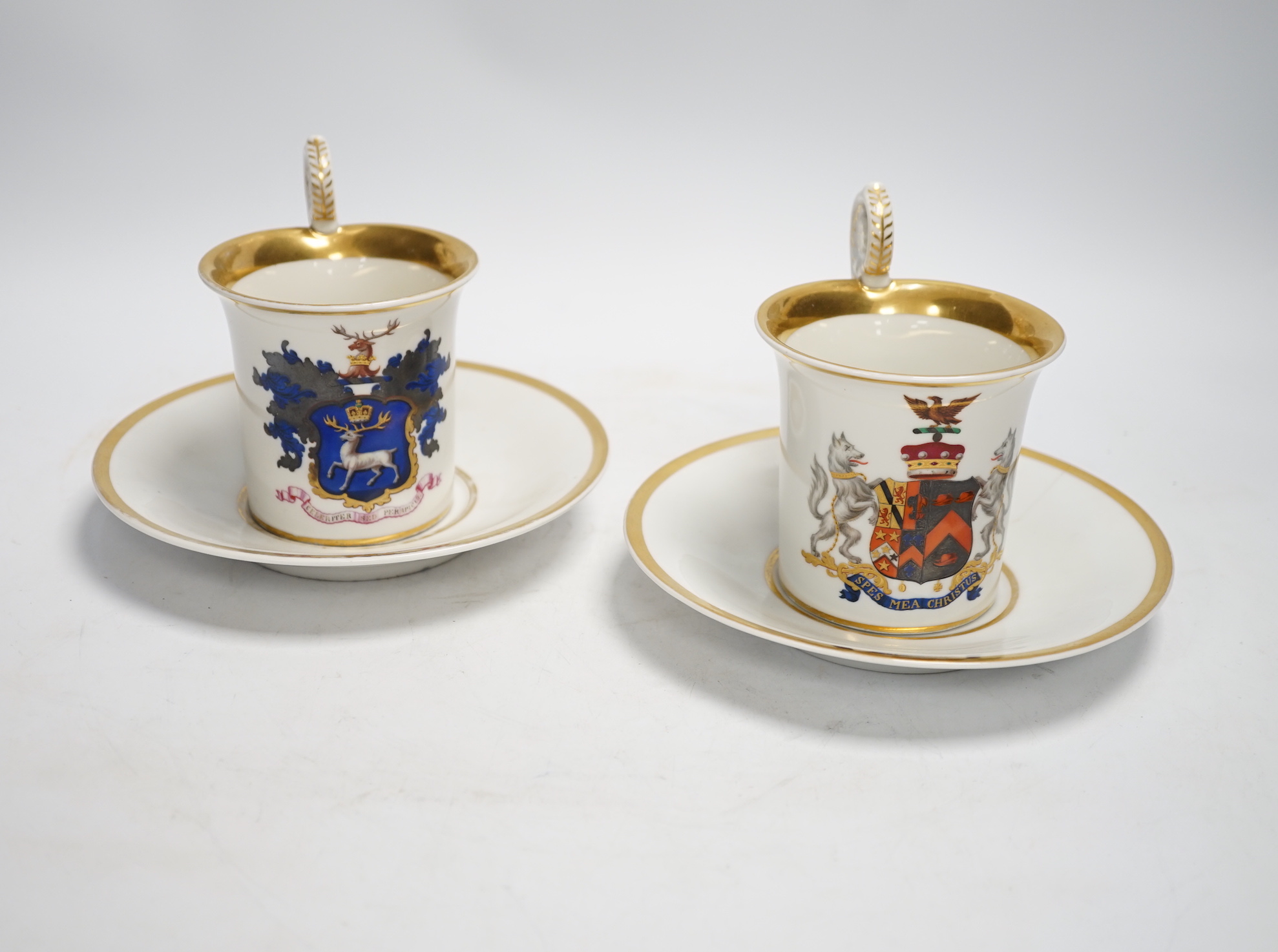 A pair of German porcelain armorial cups and saucers, one saucer reads ‘Lord Bingham s/m Y. Powell. Born 1848’
